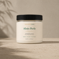 Jar of Nouvelle Eden Aloes Perle Aloe Butter Creme on a neutral background