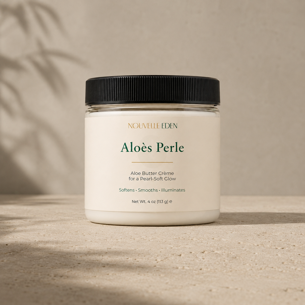 Jar of Nouvelle Eden Aloes Perle Aloe Butter Creme on a neutral background