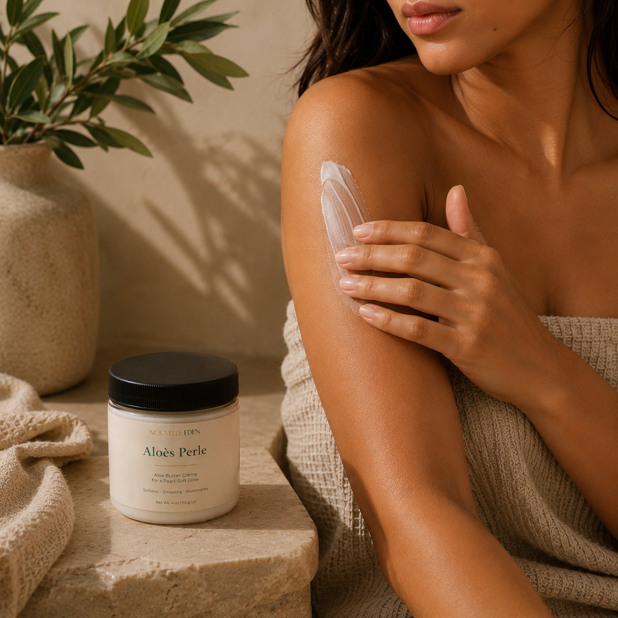 Woman applying aloe vera cream to her arm with a jar of the product next to her.